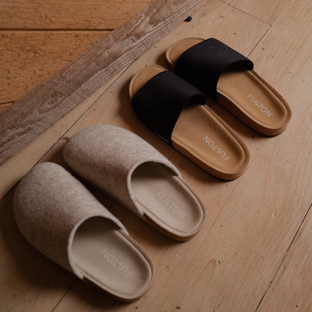 Fulton Comfort Slides and House Shoes together on a hardwood floor